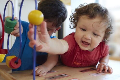 toddlers playing with toy