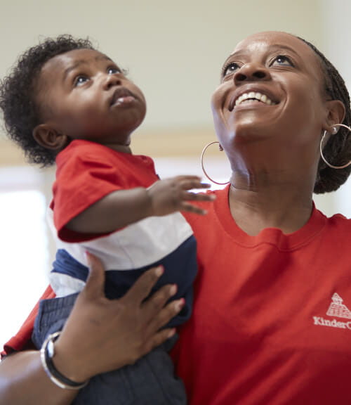 teacher holding infant