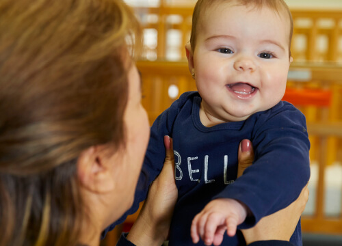 infant being held