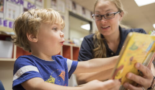 teacher reading to boy